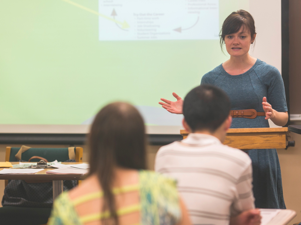 A teacher speaking in front of a group of students